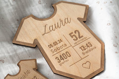 A wooden table with data on the birth of a child
